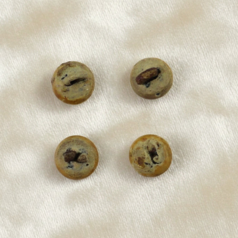 10 Lignes 1/4" Four antique composite ball shoe buttons with metal shanks. 