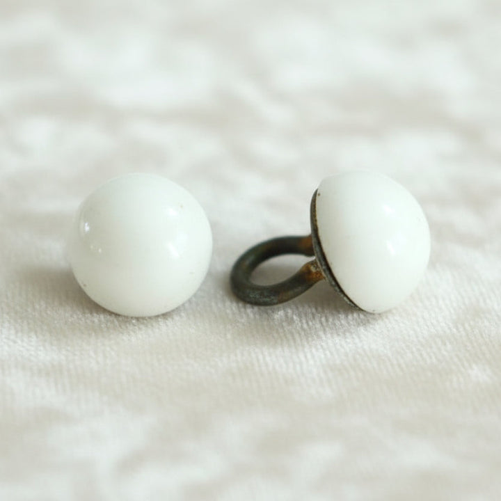Set of two Victorian opaque white glass dome buttons with a metal shank.

Measure approximately 11 lignes, 6.9 mm, or 5/16".
