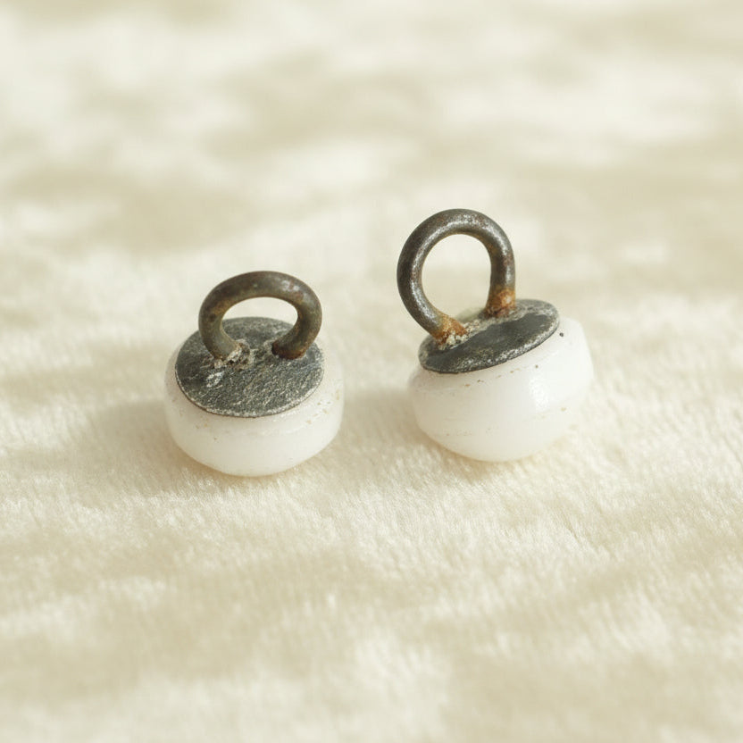 Set of two Victorian opaque white glass dome buttons with a metal shank.

Measure approximately 11 lignes, 6.9 mm, or 5/16".