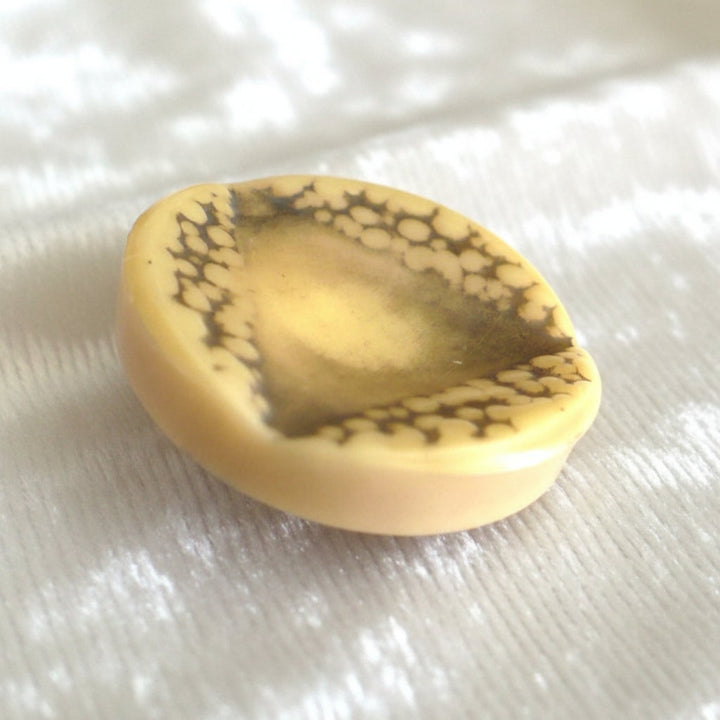 Vintage late 1940s to 1950s Brutalist celluloid coat buttons – set of four.