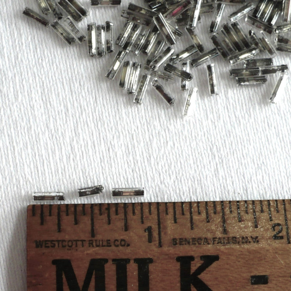 1920s Clear Mercury Glass Bugle Beads, with ruler to show scale.