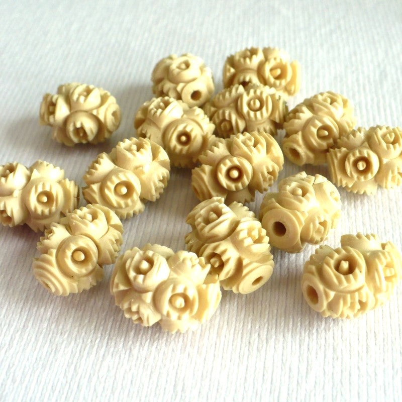 1930s French Ivory Celluloid Beads on a white fabric background.