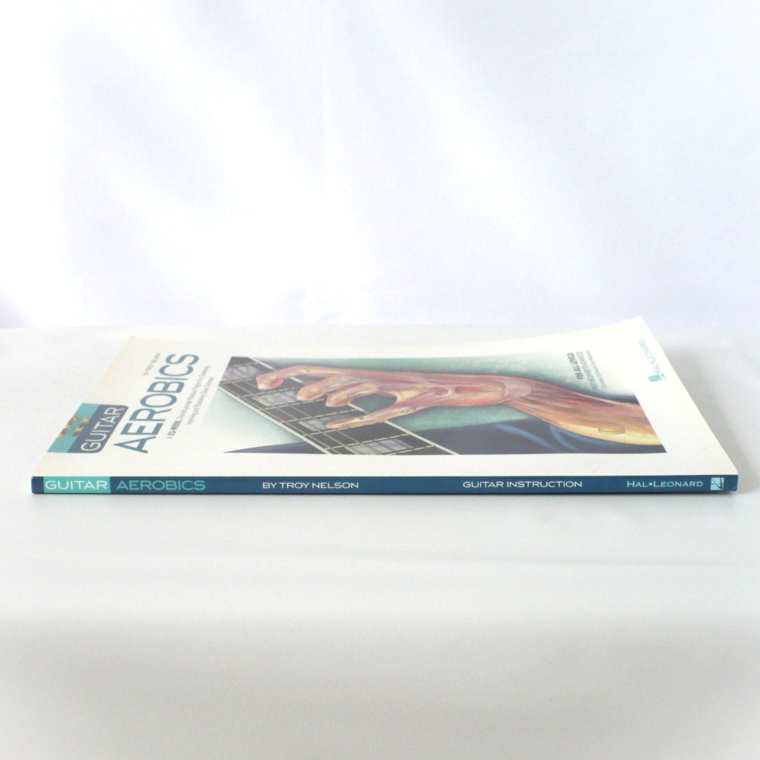 Side view of the Guitar Aerobics book spine, showing the title, author, and Hal Leonard branding clearly.