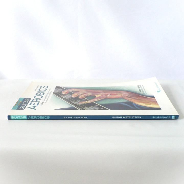 Side view of the Guitar Aerobics book spine, showing the title, author, and Hal Leonard branding clearly.