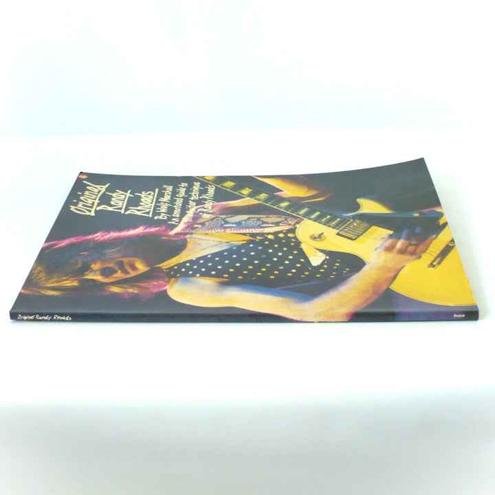 Spine view of the 1986 Original Randy Rhoads guitar book showing the Amsco logo and excellent, uncreased condition of the binding.