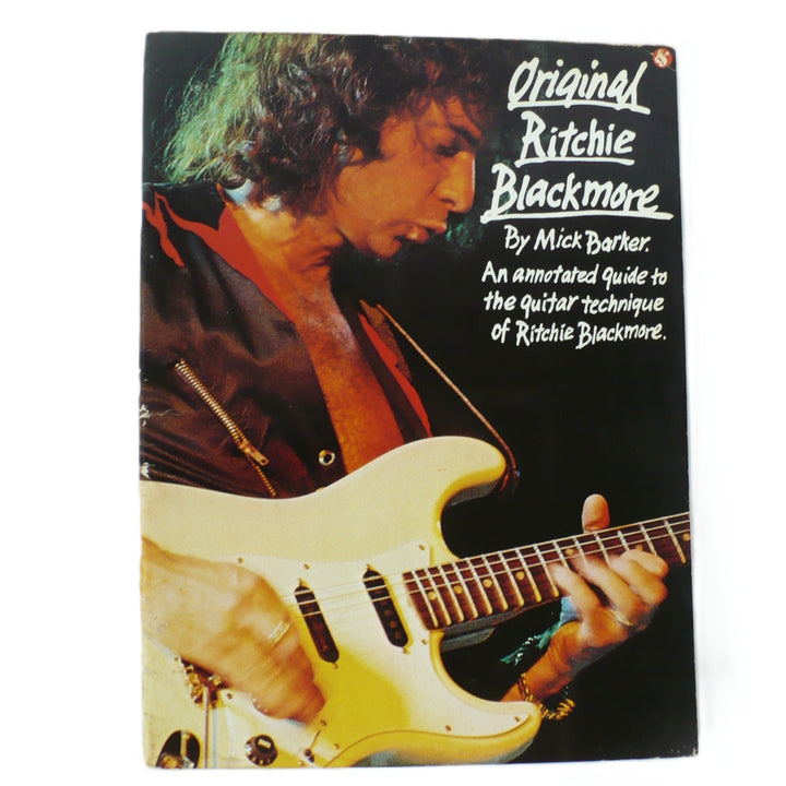 Front cover of 1987 Original Ritchie Blackmore guitar tab book by Mick Barker featuring Ritchie with his signature white Fender Stratocaster with white background.