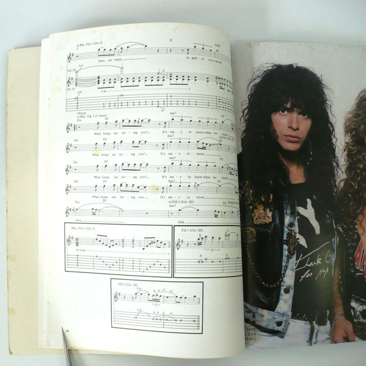 Interior page of 1990 XYZ guitar tablature book by Cherry Lane Music featuring musical notation and band photography.