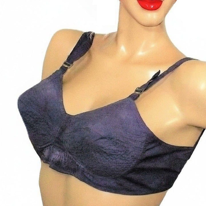 Mannequin wearing a purple vintage bra on a white background