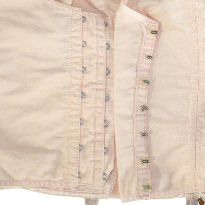 Peach 1940s Full Busted Babe Longline Bra with Girdle Hooks on a mannequin against a white background. Hooks.