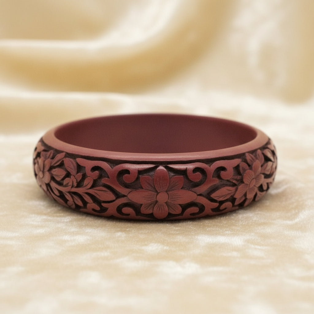 Vintage Auspicious Carved Red Cinnabar Bangle Bracelet on velvet background.