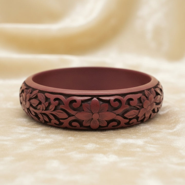 Vintage Auspicious Carved Red Cinnabar Bangle Bracelet on velvet background.