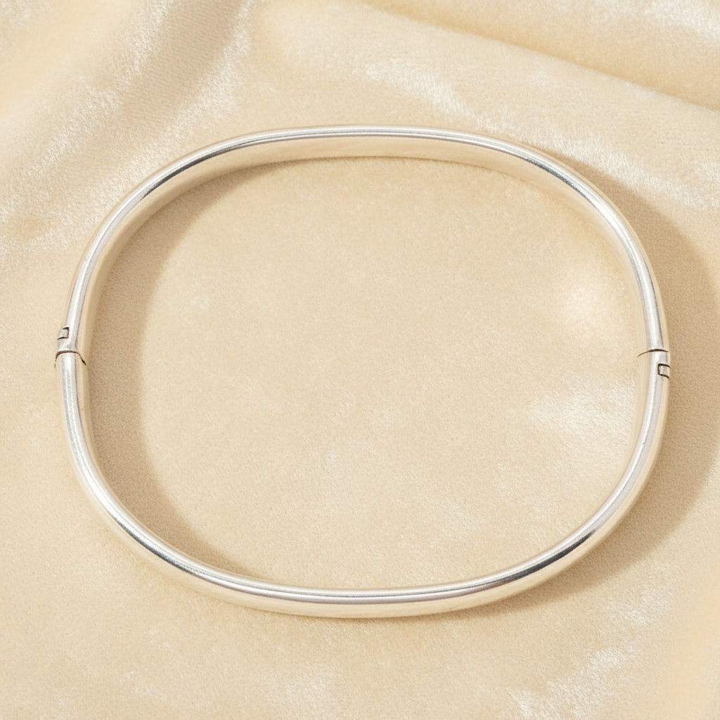 1970s Vintage  Sterling Oval Charnière Bangle Bracelet on velvet background.