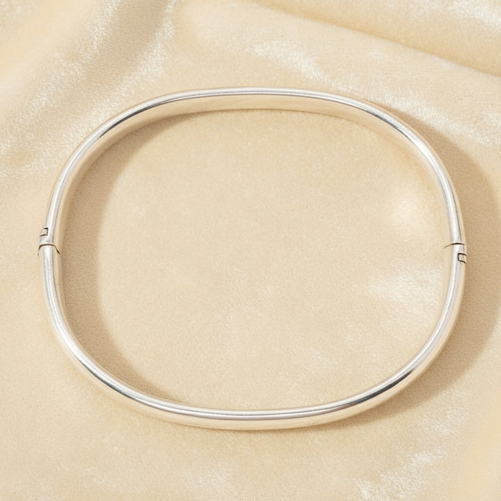 1970s Vintage  Sterling Oval Charnière Bangle Bracelet on velvet background.