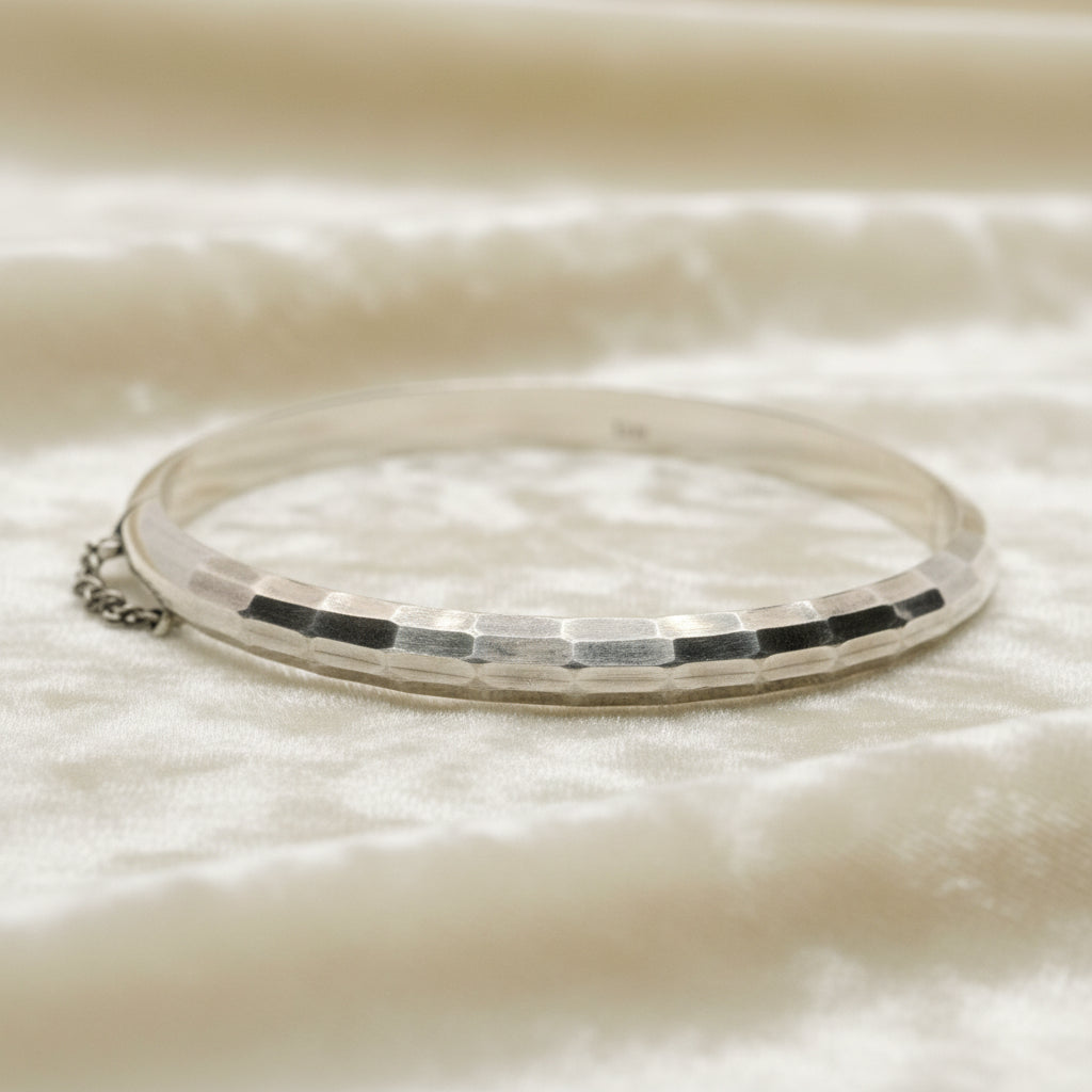 1970 Vintage Sterling Silver Faceted Charnière Hinged Bangle Bracelet on velvet background.
