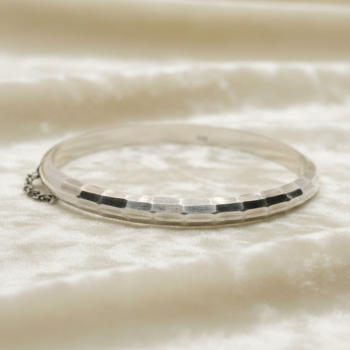 1970 Vintage Sterling Silver Faceted Charnière Hinged Bangle Bracelet on velvet background.