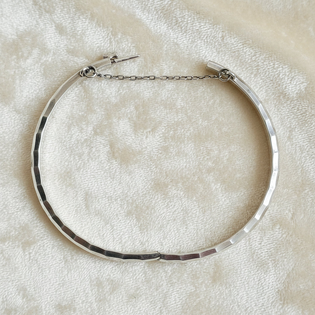 1970 Vintage Sterling Silver Faceted Charnière Hinged Bangle Bracelet, opened, on velvet background.