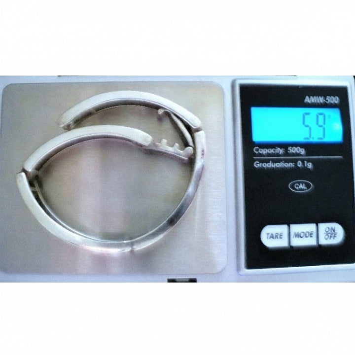 Industria Argentina Sterling Silver Charnières Bangle Bracelet MCM on jewelry scale.