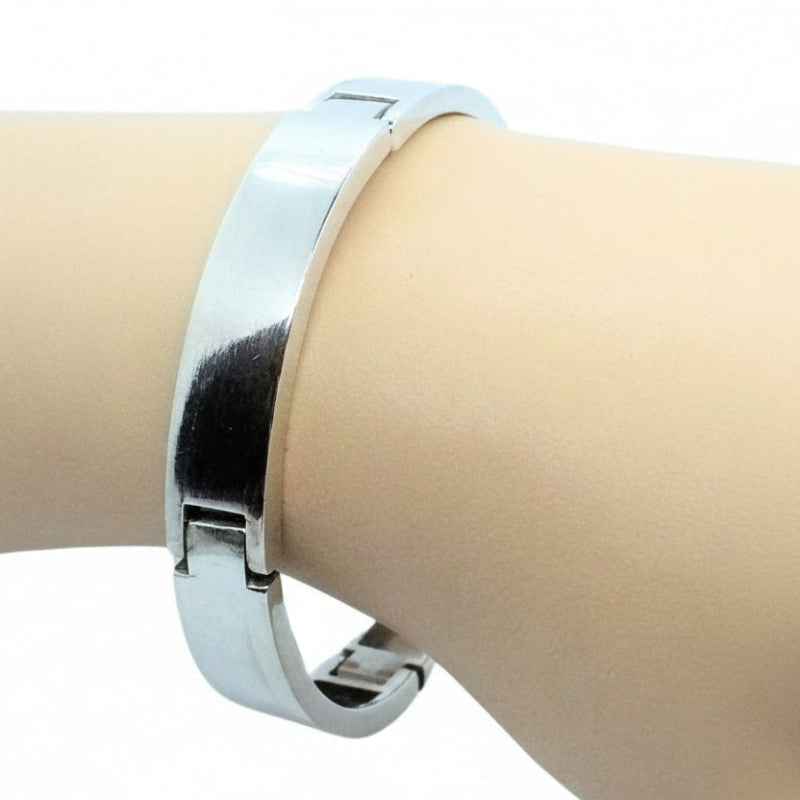 Silver bracelet on a mannequin arm against a white background