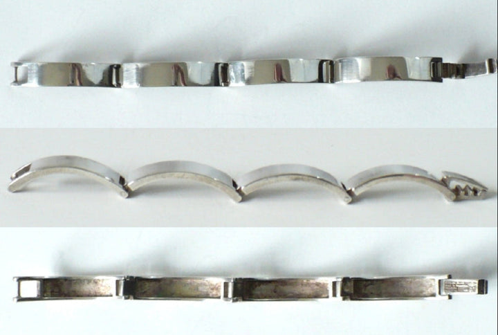 Three views of the bracelet montage, opened from above, side, and underside.