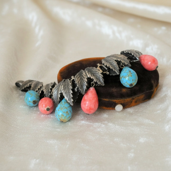 1930s Charm Bracelet with Hubbell Glass Beads, Native American-Inspired, displayed on box.