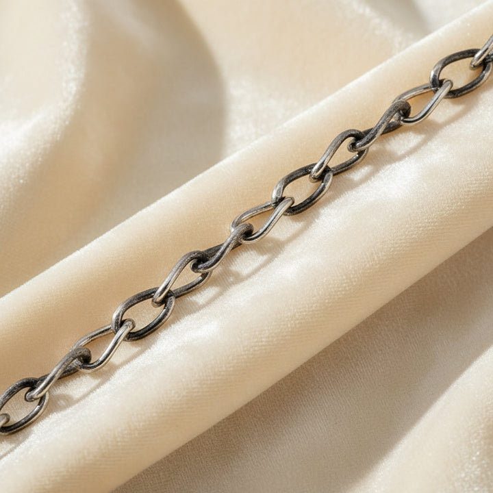 1940s Vintage Slender Siam Silver Chain Bracelet section enlarged to show links on velvet background.