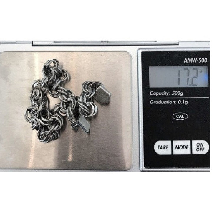 1950 Sterling  silver double link charm chain Lang Bracelet on jewelry scale.