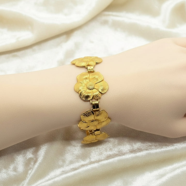 1950s Vintage Post War Gold Vermeil Blooming Flowers Link Bracelet on wrist with white background.
