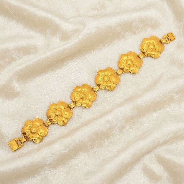 1950s Vintage Post War Gold Vermeil Blooming Flowers Link Bracelet with velvet background.