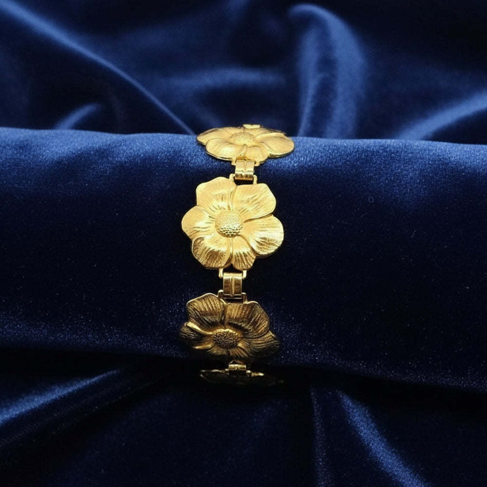 1950s Vintage Post War Gold Vermeil Blooming Flowers Link Bracelet with velvet background.
