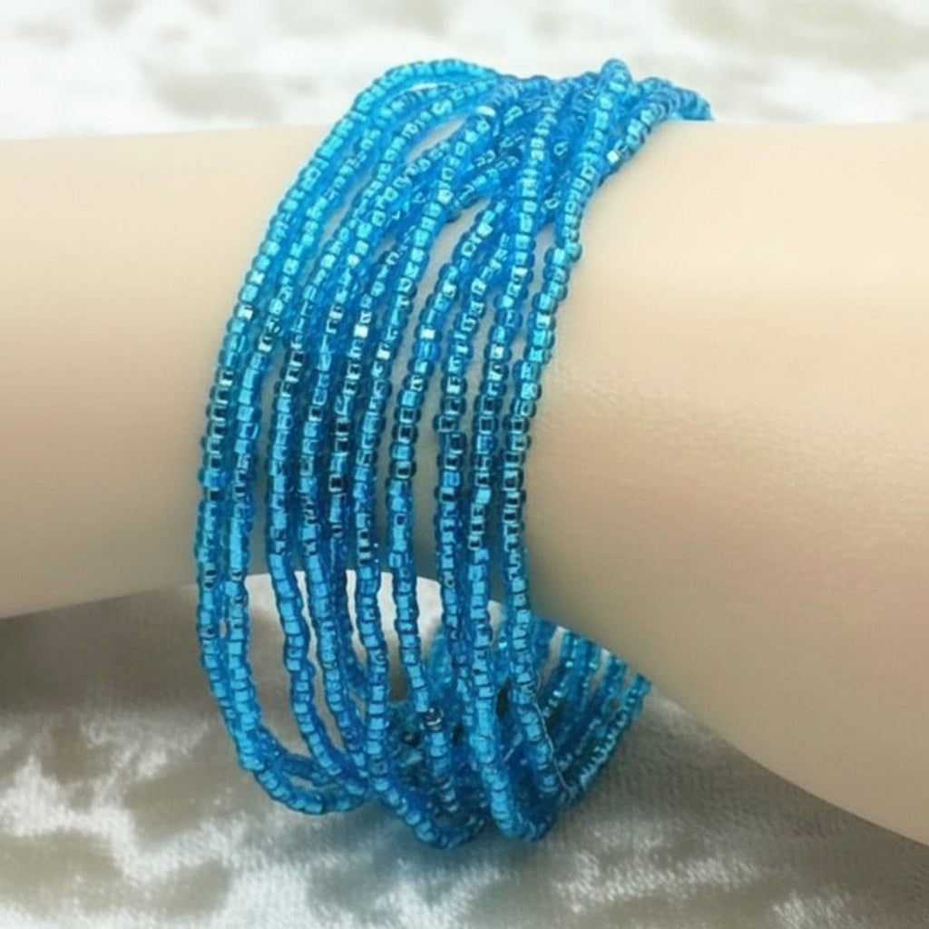 1960s Vintage  Mermaid Blue Beaded Bracelet on wrist.