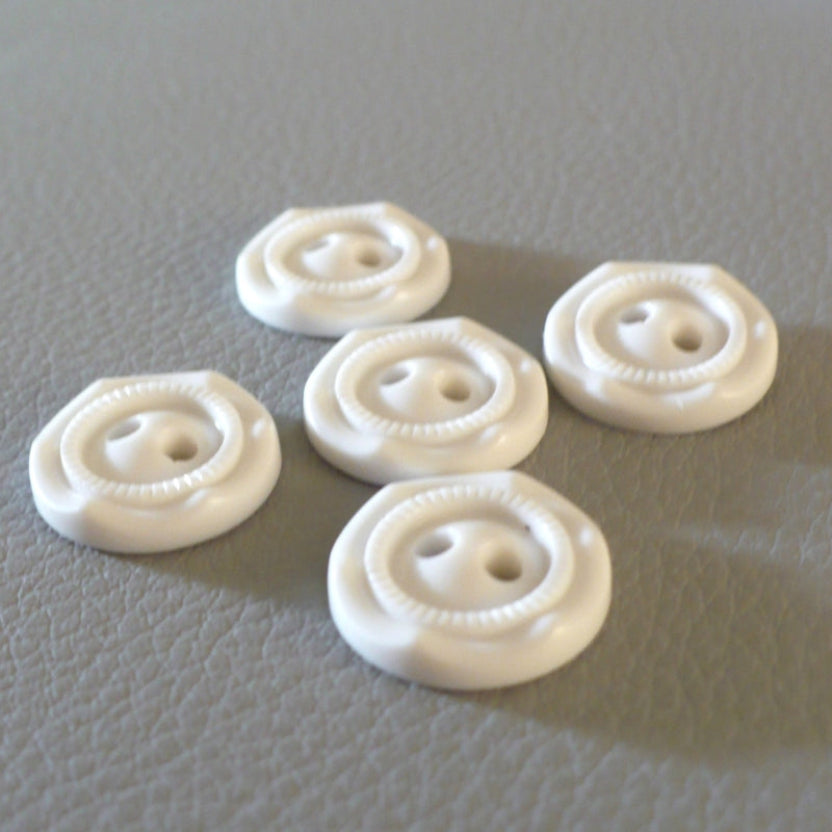 24L Set of Five Opaque White Celluloid Two Hole Buttons, arranged on a gray textured surface.