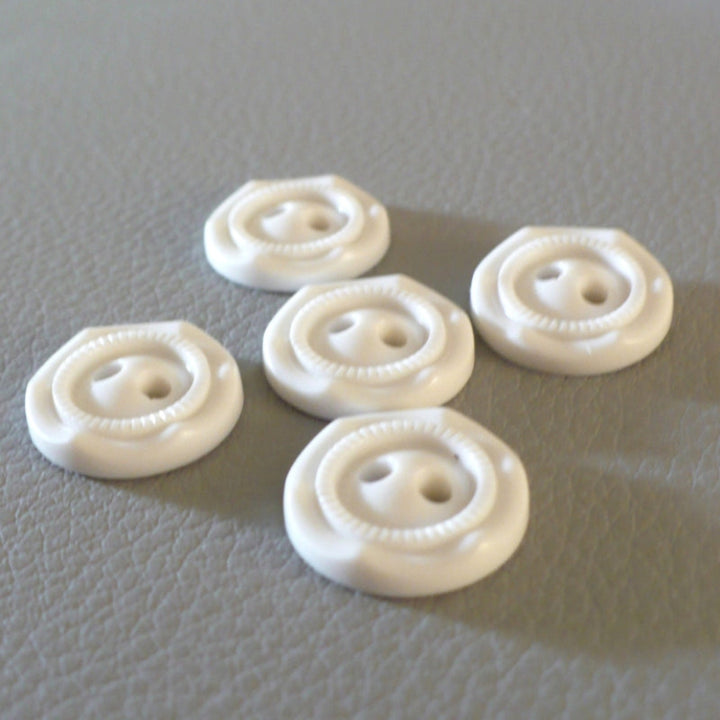 24L Set of Five Opaque White Celluloid Two Hole Buttons, arranged on a gray textured surface.