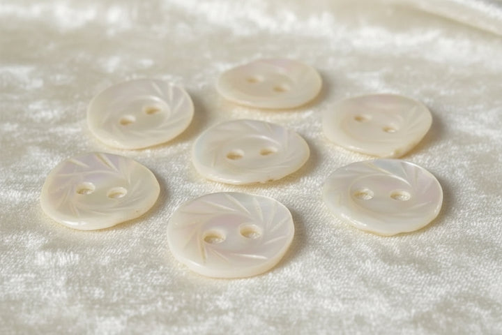 13L Set of Seven Two-Hole Fancy Conch Shell Dimi Buttons, 1/4".