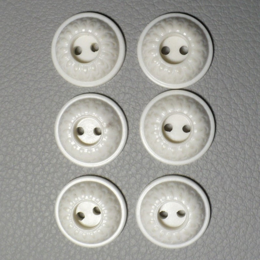 23L Set of Six White Celluloid Whistle Buttons, fronts on gray background.