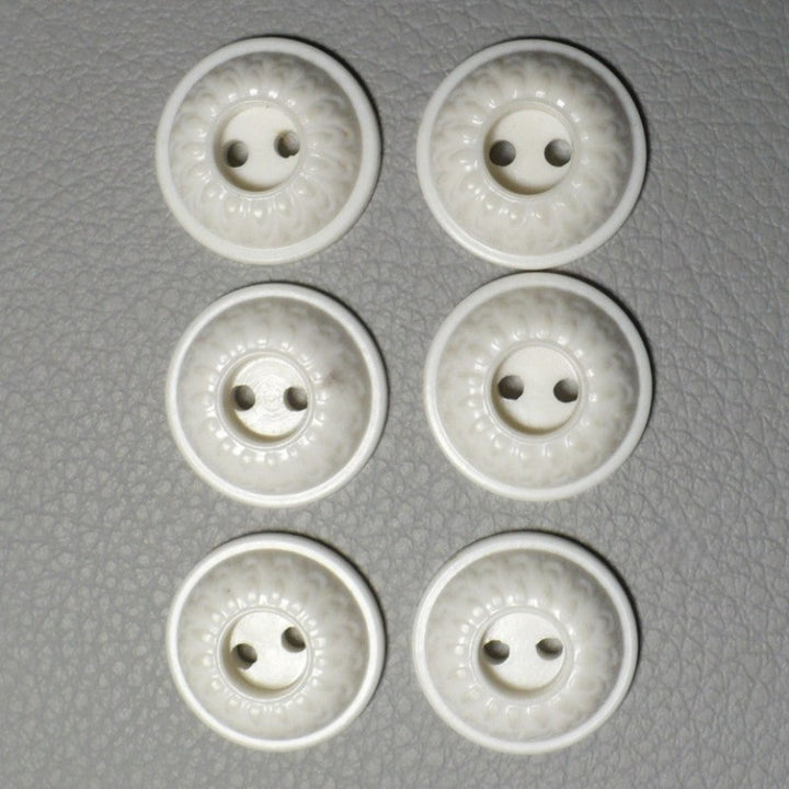 23L Set of Six White Celluloid Whistle Buttons, fronts on gray background.