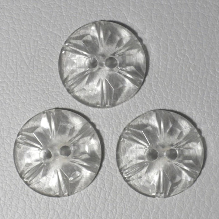 Tops or faces of 30L Set of Three 1950s Clear as Crystal Lucite Two-Hole Buttons, 3/4", on gray background.
