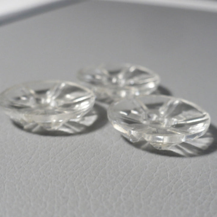 Side view of 1950s Clear as Crystal Lucite Two-Hole Buttons, 3/4", on gray background.