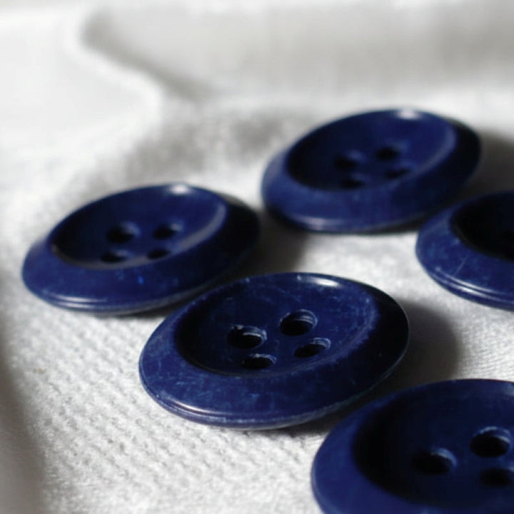 22L 1930s Navy Blue Four-Hole Casein Buttons 9/16 Inches viewed at an angle side.