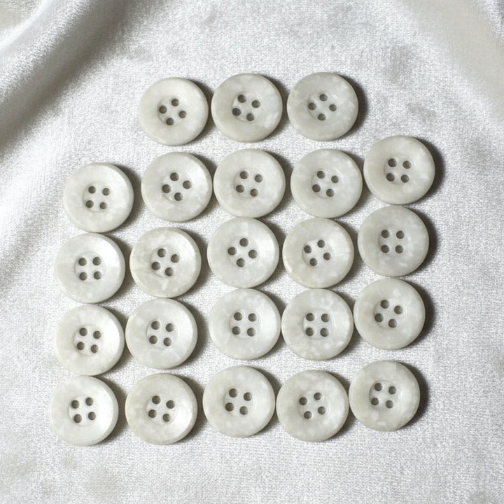 22L Set of 23 Four-Hole Speckled Casein White Buttons.
