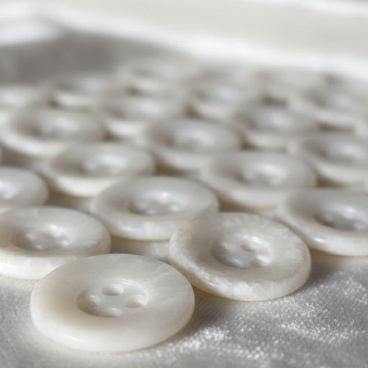 22L Set of 23 Four-Hole Speckled Casein White Buttons.