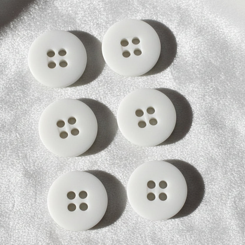 23L Set of Six White Four Hole Casein Buttons.