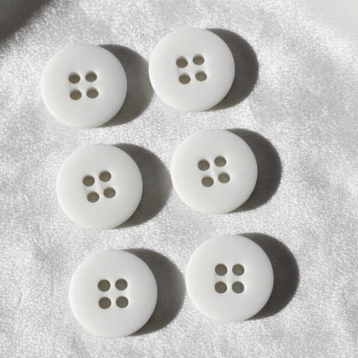 23L Set of Six White Four Hole Casein Buttons.