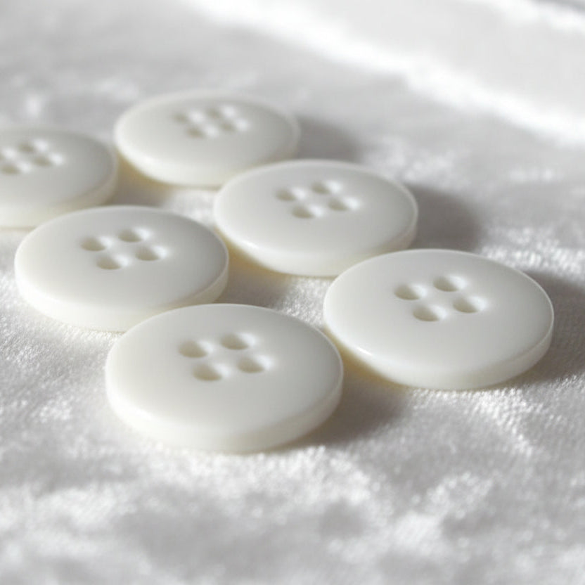 23L Set of Six White Four Hole Casein Buttons.