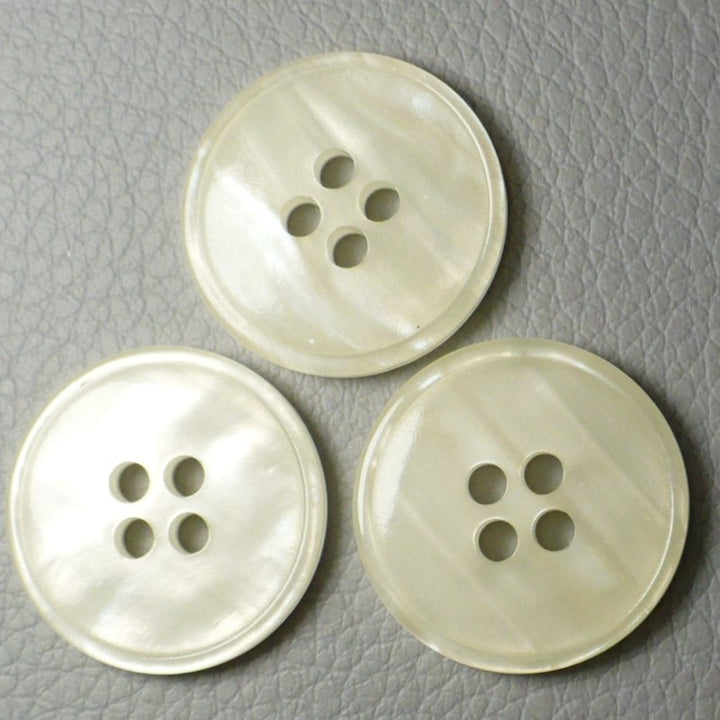 30L Set of Three Pearly White Layered Four Hole Buttons, 3/4", fronts. arranged on a textured gray background.