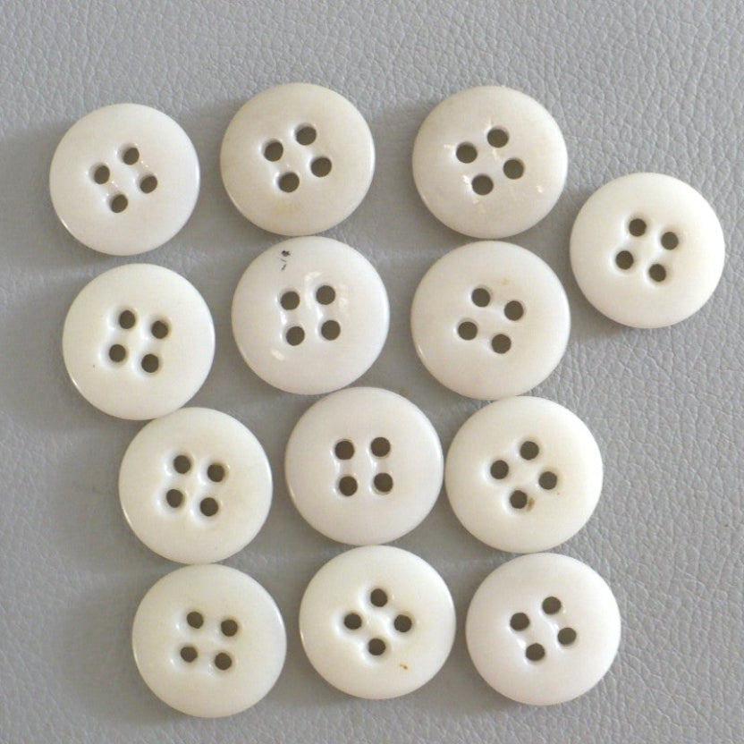 27L Set of 13, 1940s Matte Off-White Four-Hole Casein Buttons.