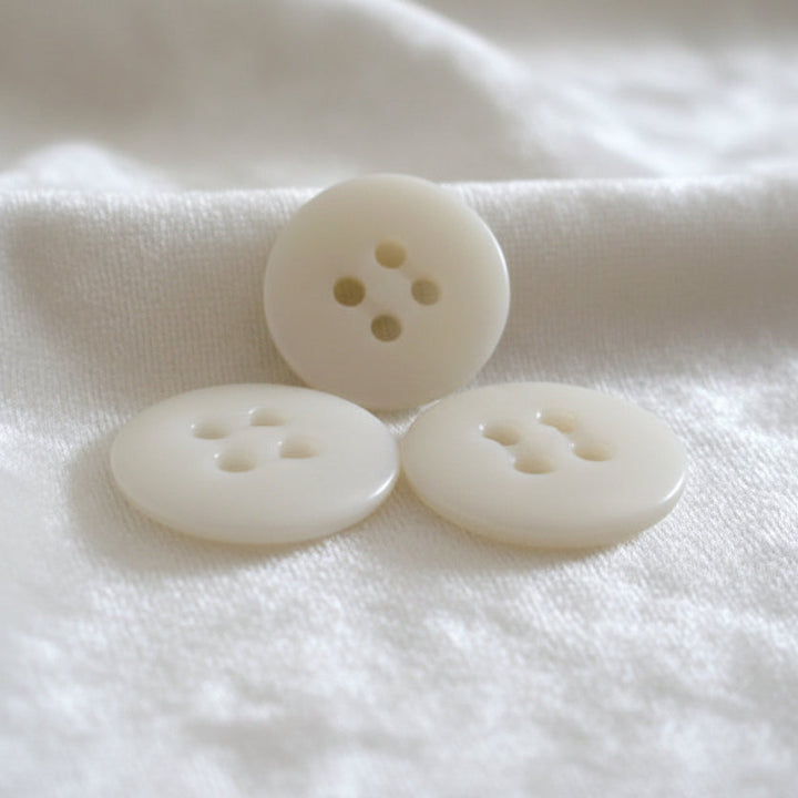 27L Set of Three Matte Off-White Four Hole Casein Trouser Buttons.