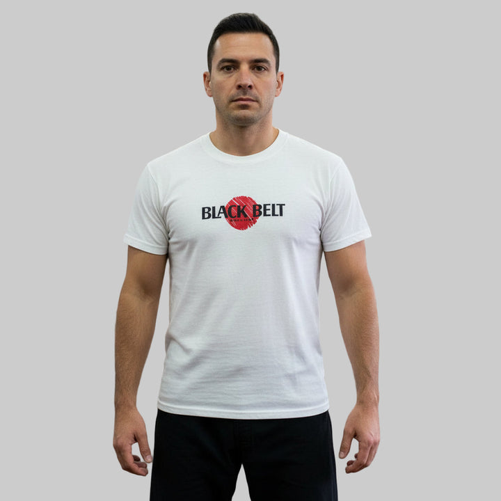 Man wearing a vintage 1980s white t-shirt with 'Black Belt' logo with plain background.