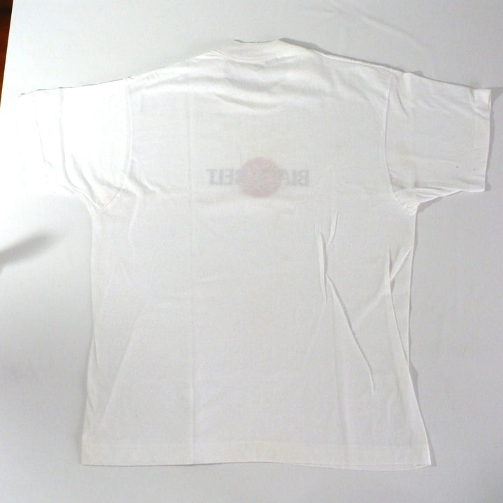 Vintage 1980s white t-shirt with 'Black Belt' logo,plain back of shirt, on a white table top background.
