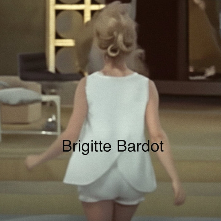 Woman in a white dress walking in an indoor setting with 'Brigitte Bardot' text overlay.