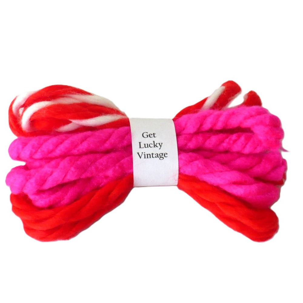 A collection of vintage yarn hair ties in Valentine's Day colors.
